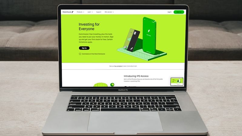 A laptop displays a digital investment platform website featuring a vibrant green design. The homepage emphasizes investment accessibility for everyone, showcasing various features of the application.