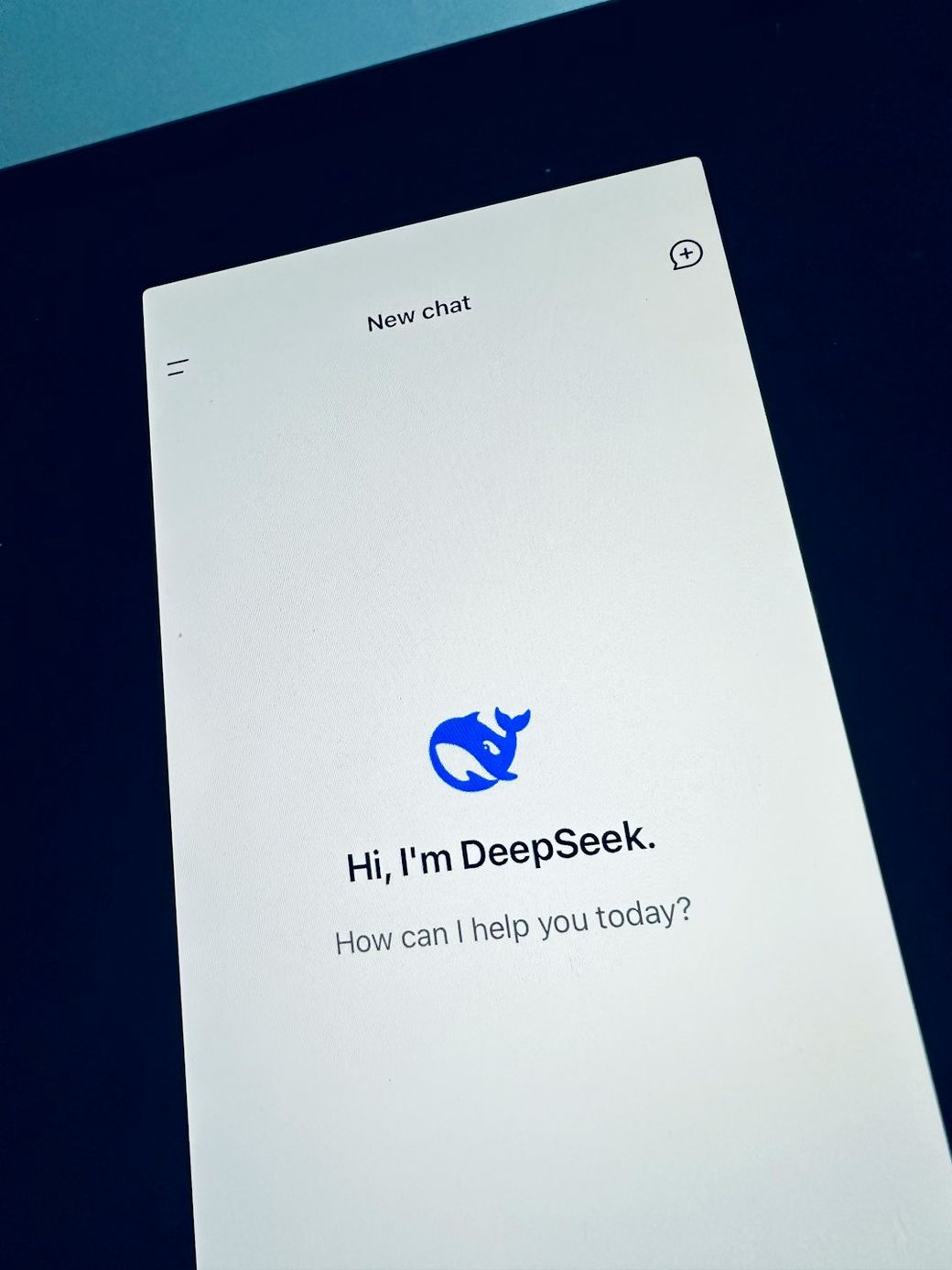 The image showcases a smartphone screen displaying a chatbot interface with a welcoming message. It features a logo and prompts user interaction. — Credit: Photo by John Cameron on Unsplash