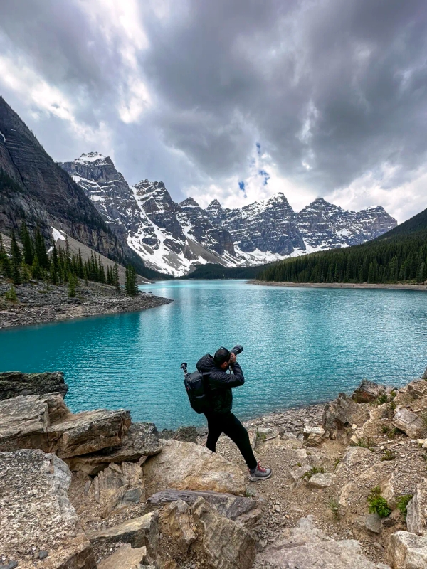 Burak Arik at Moraine Lake with professional camera gear, ready for landscape photography in Banff National Park, Canada