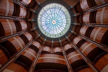 Same photo after RAW processing showing recovered shadows, visible window details, and vibrant colors