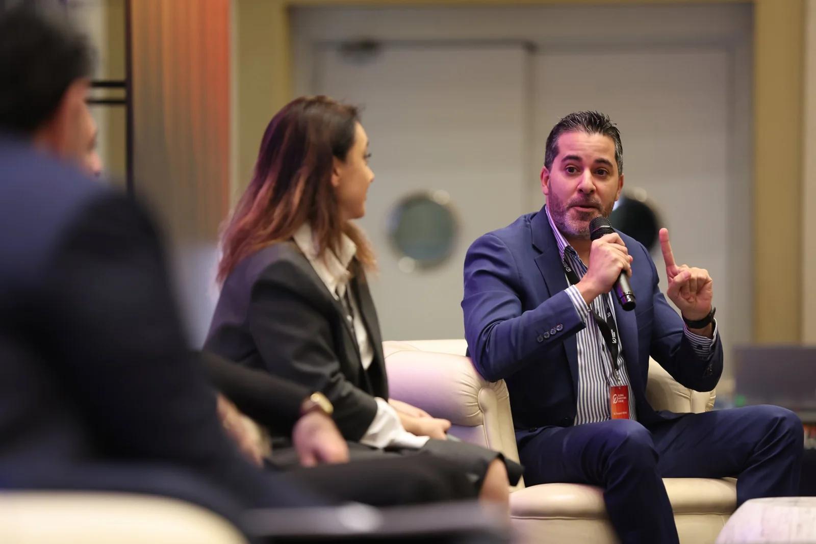 A conversation between seated participants at GIF Georgia 2025.