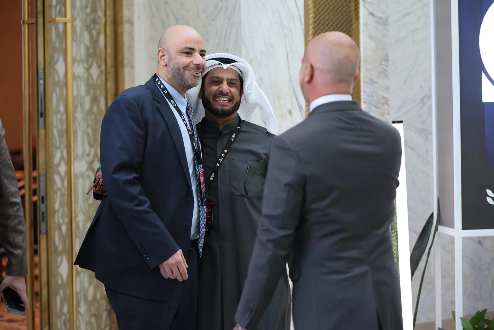 Three delegates in conversation at GIF Georgia 2025.