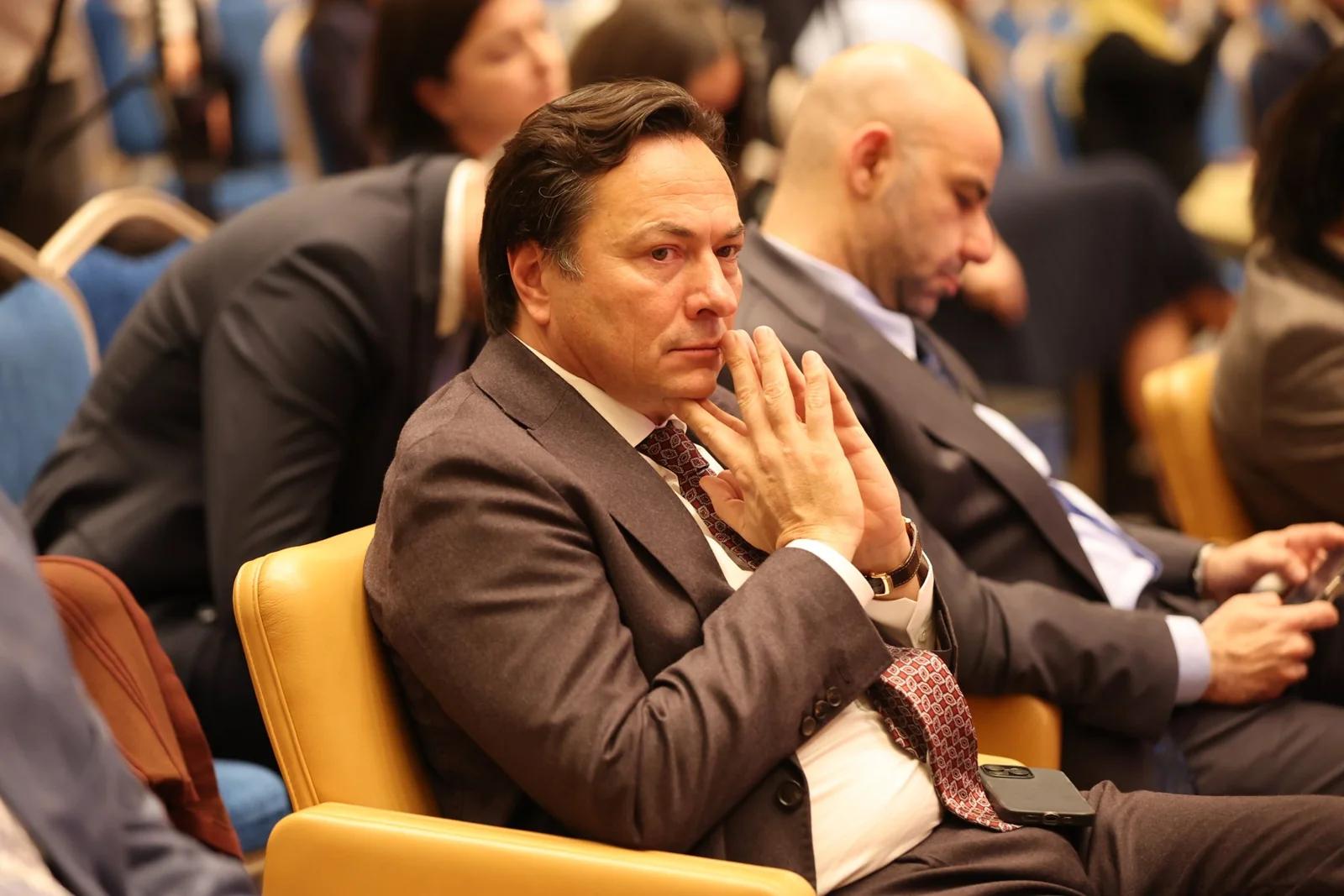 A participant listening to a discussion at GIF Georgia 2025.