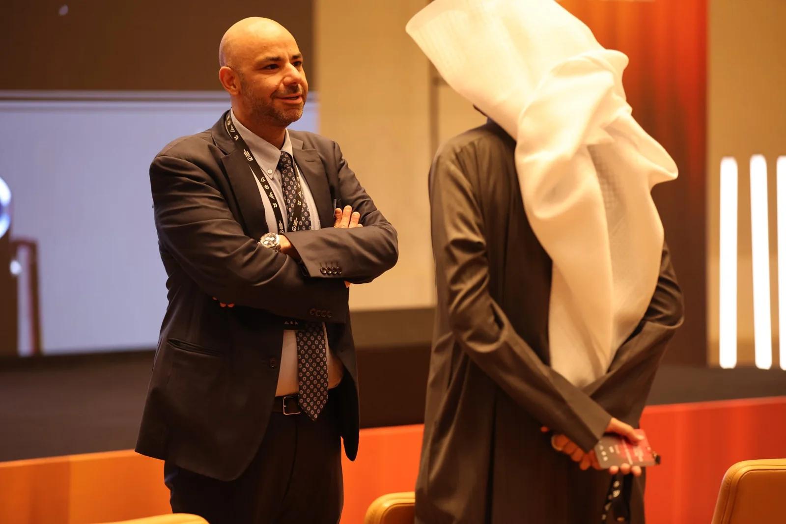 Two delegates sharing a smile at GIF Georgia 2025.