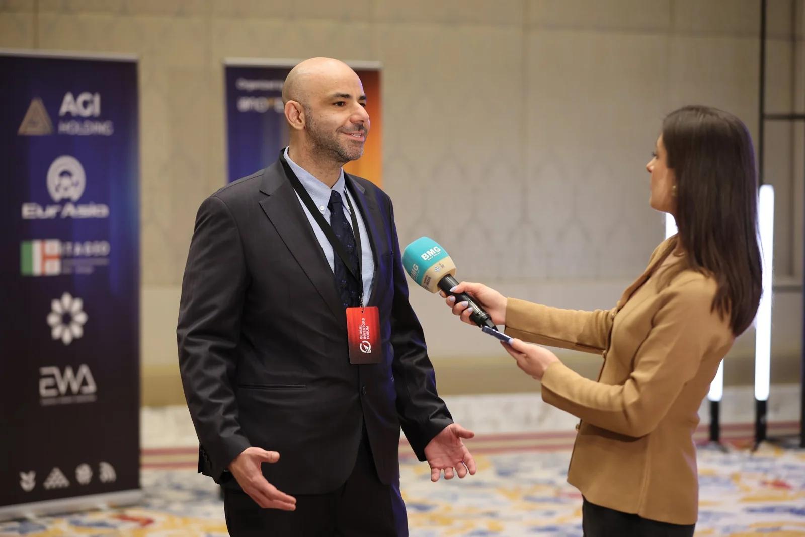 An interview beside the forum backdrop at GIF Georgia 2025.