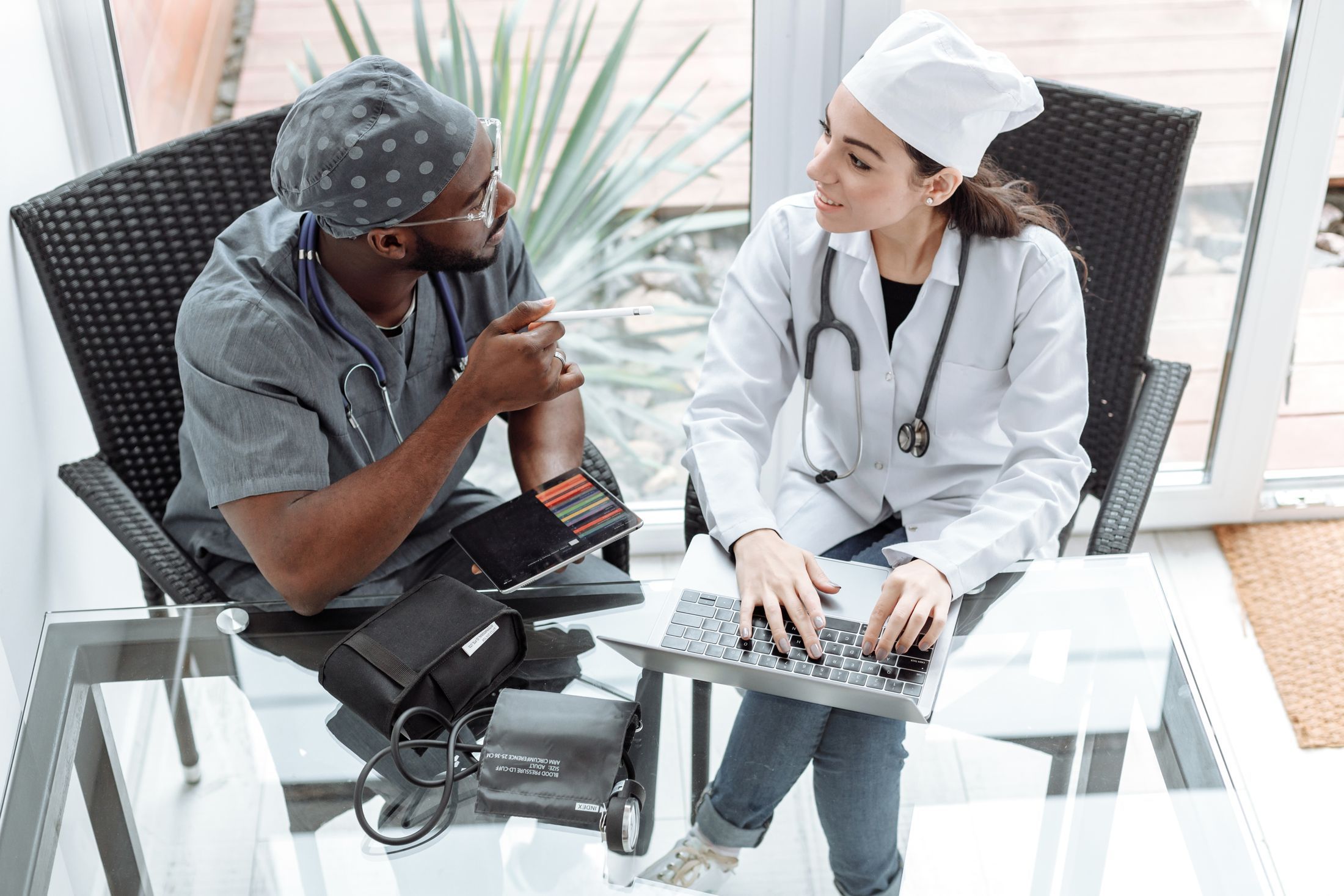 Two medical professionals reviewing information together on a laptop