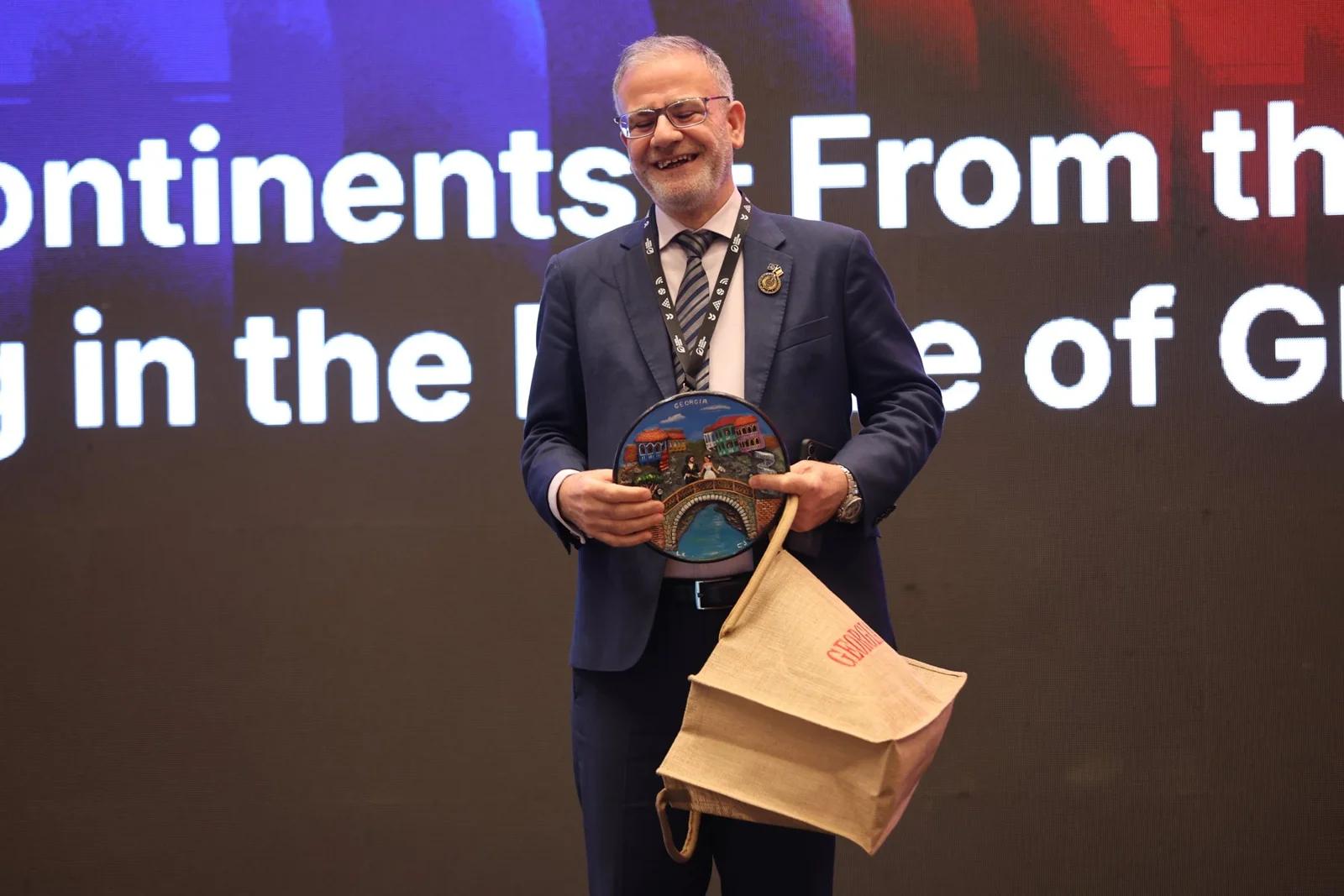 An appreciation presentation on stage at GIF Georgia 2025.