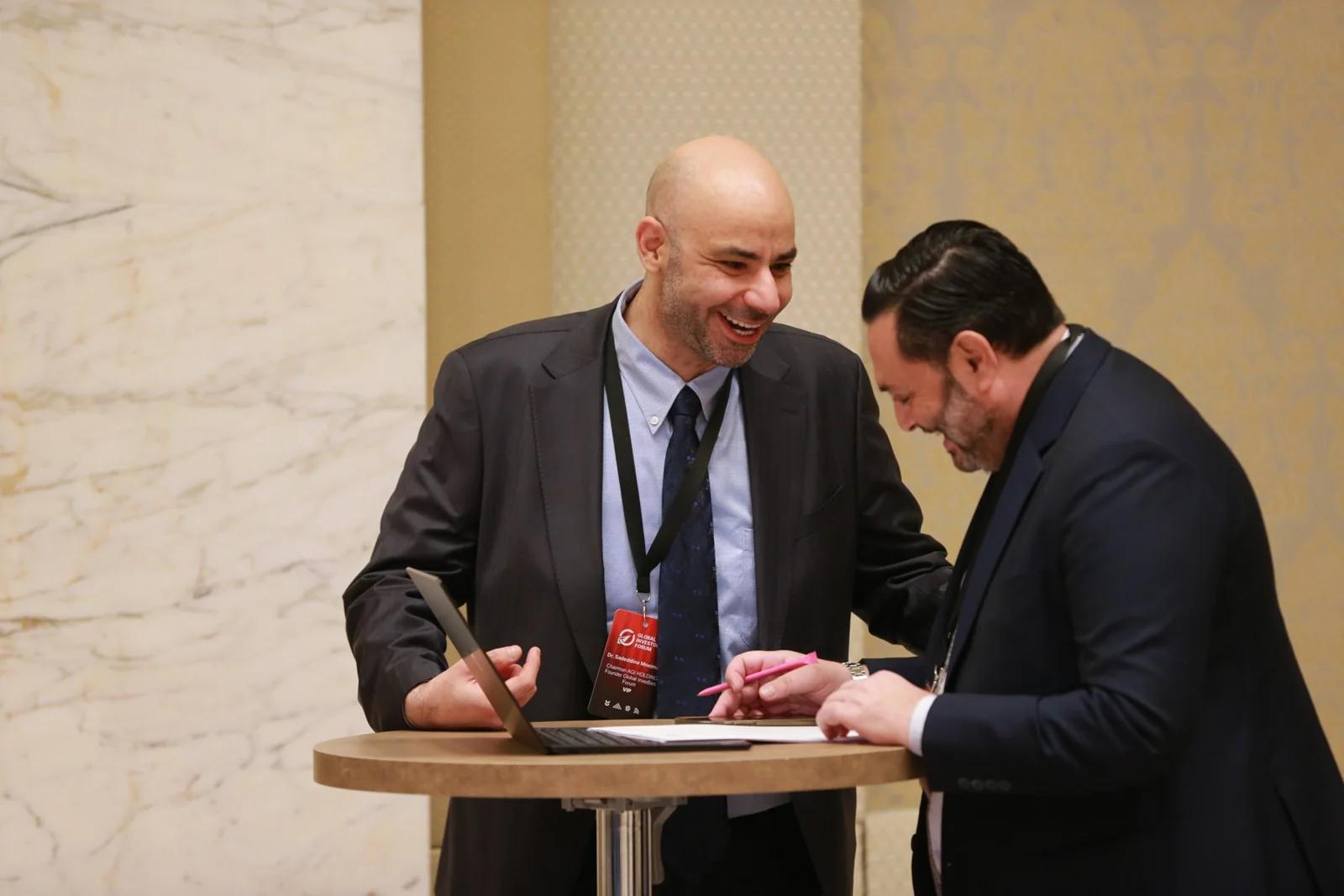 Two delegates reviewing documents at GIF Georgia 2025.