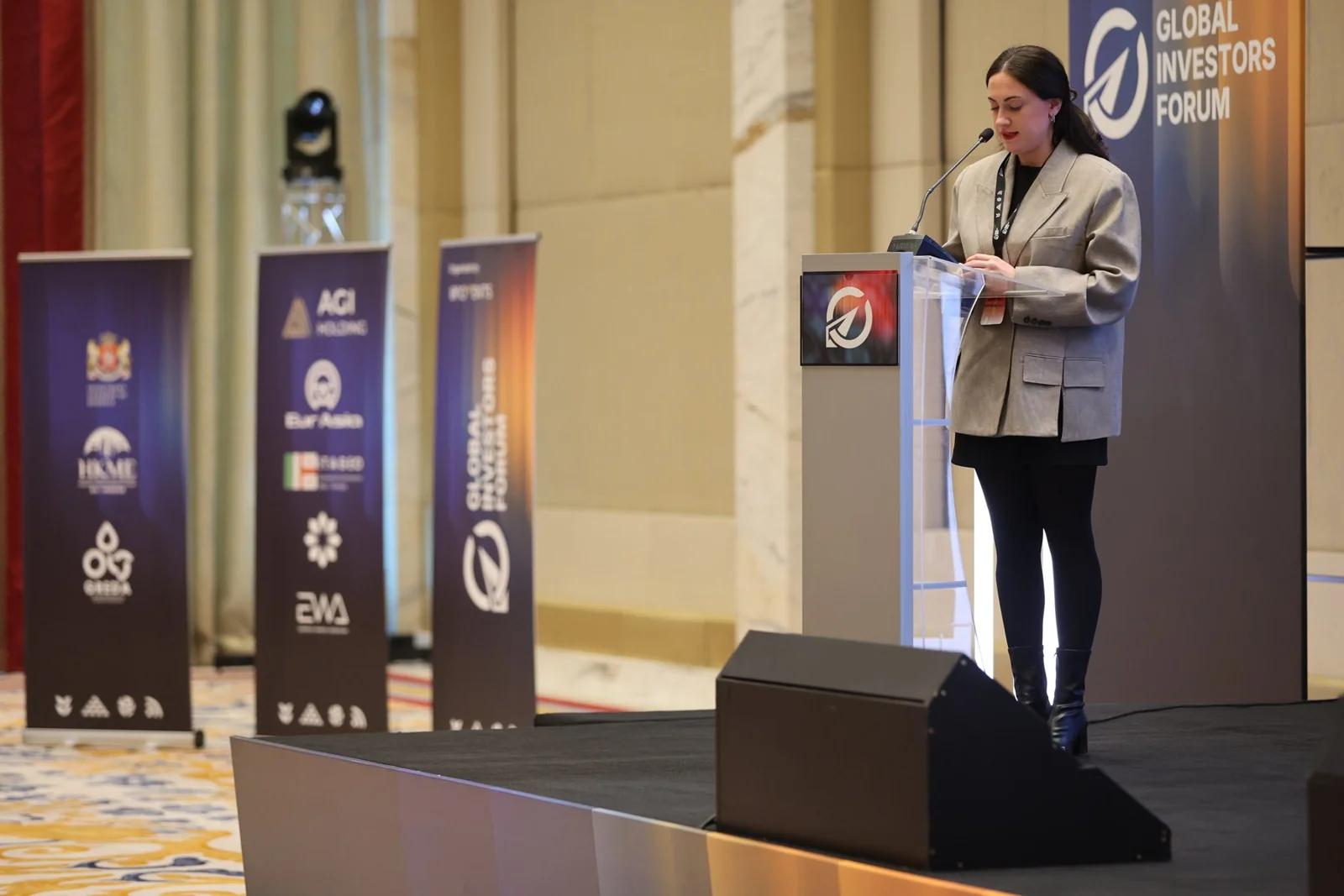 A speaker introducing a session at GIF Georgia 2025.
