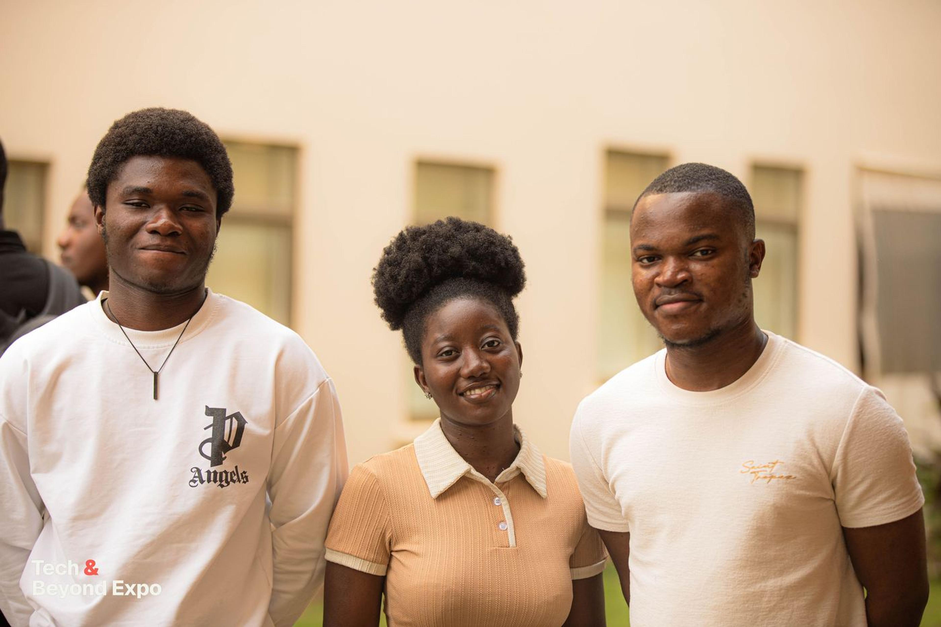 Three attendees smiling for the camera