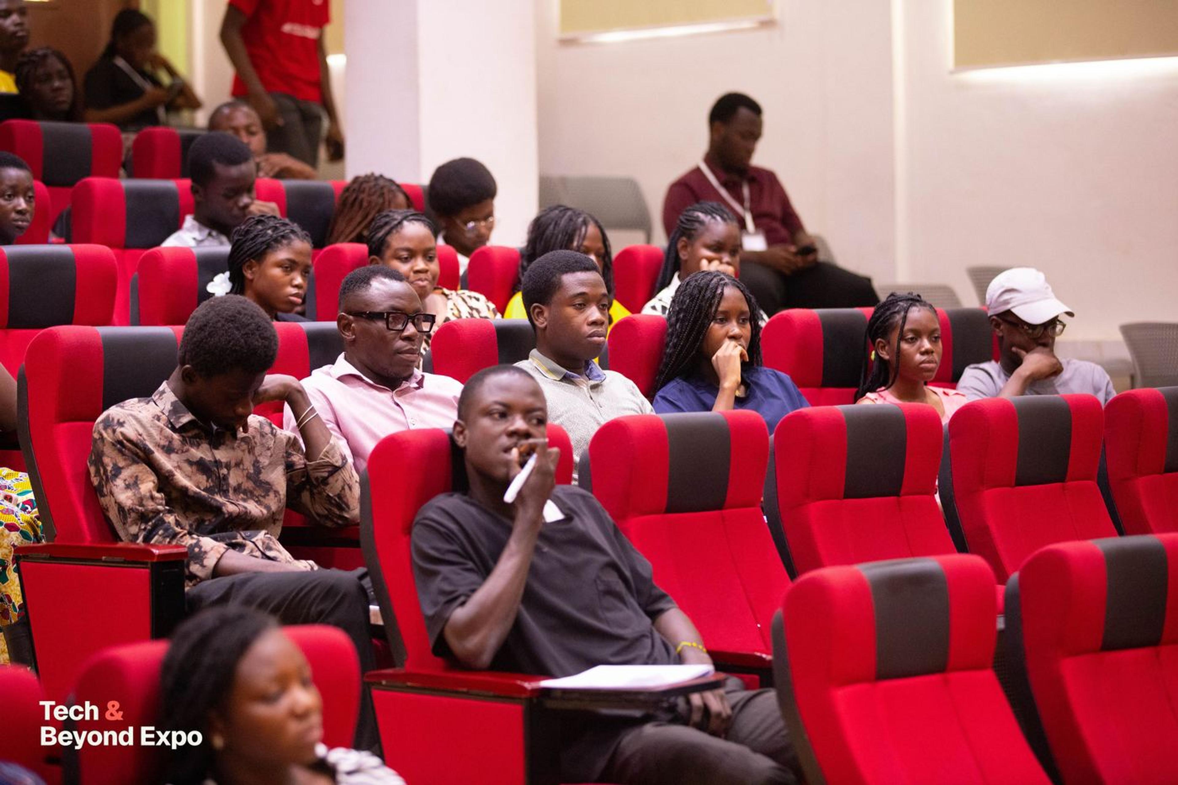 Attendees taking notes in the lecture hall