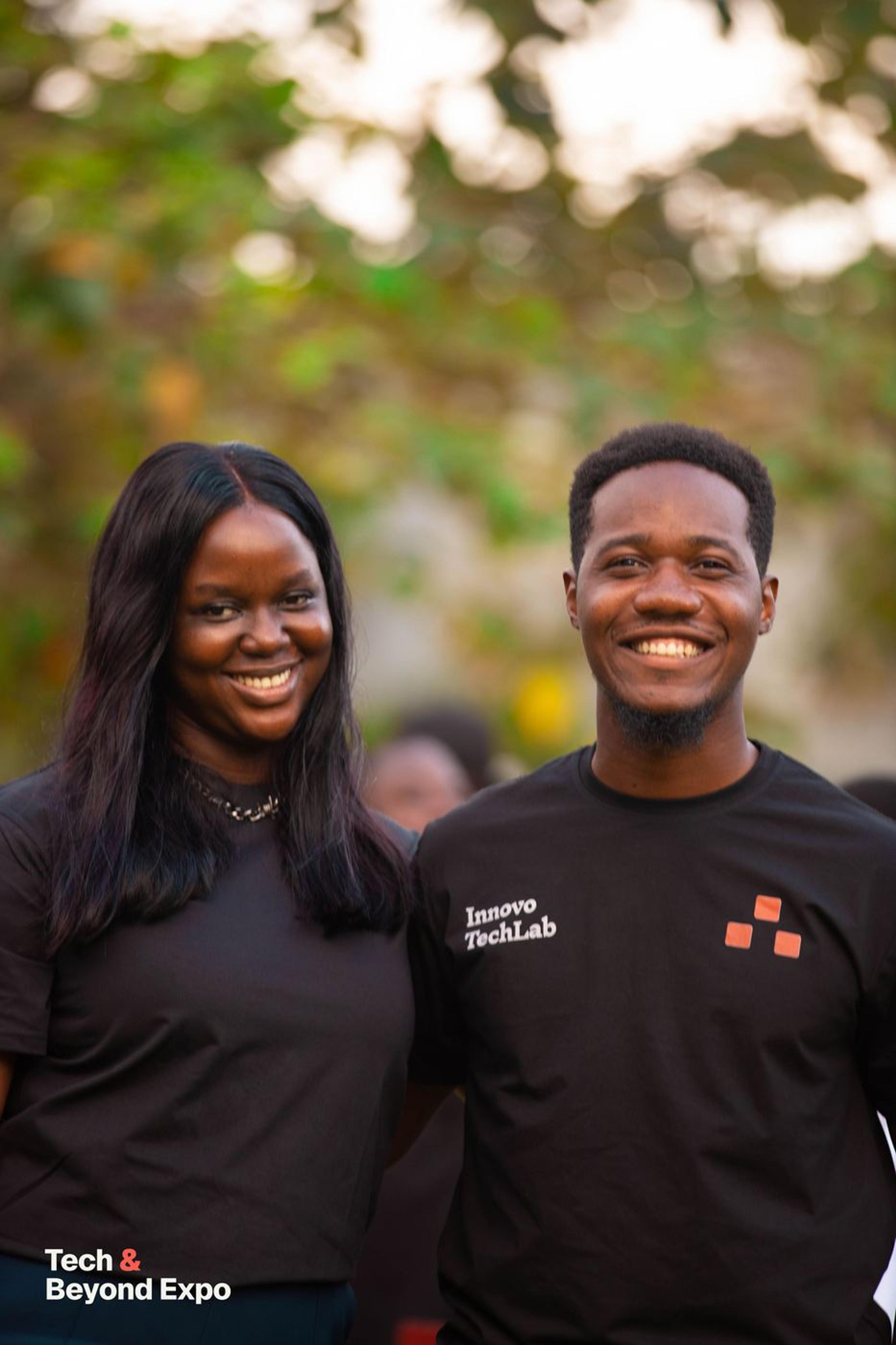 Two members of the team smiling outdoors