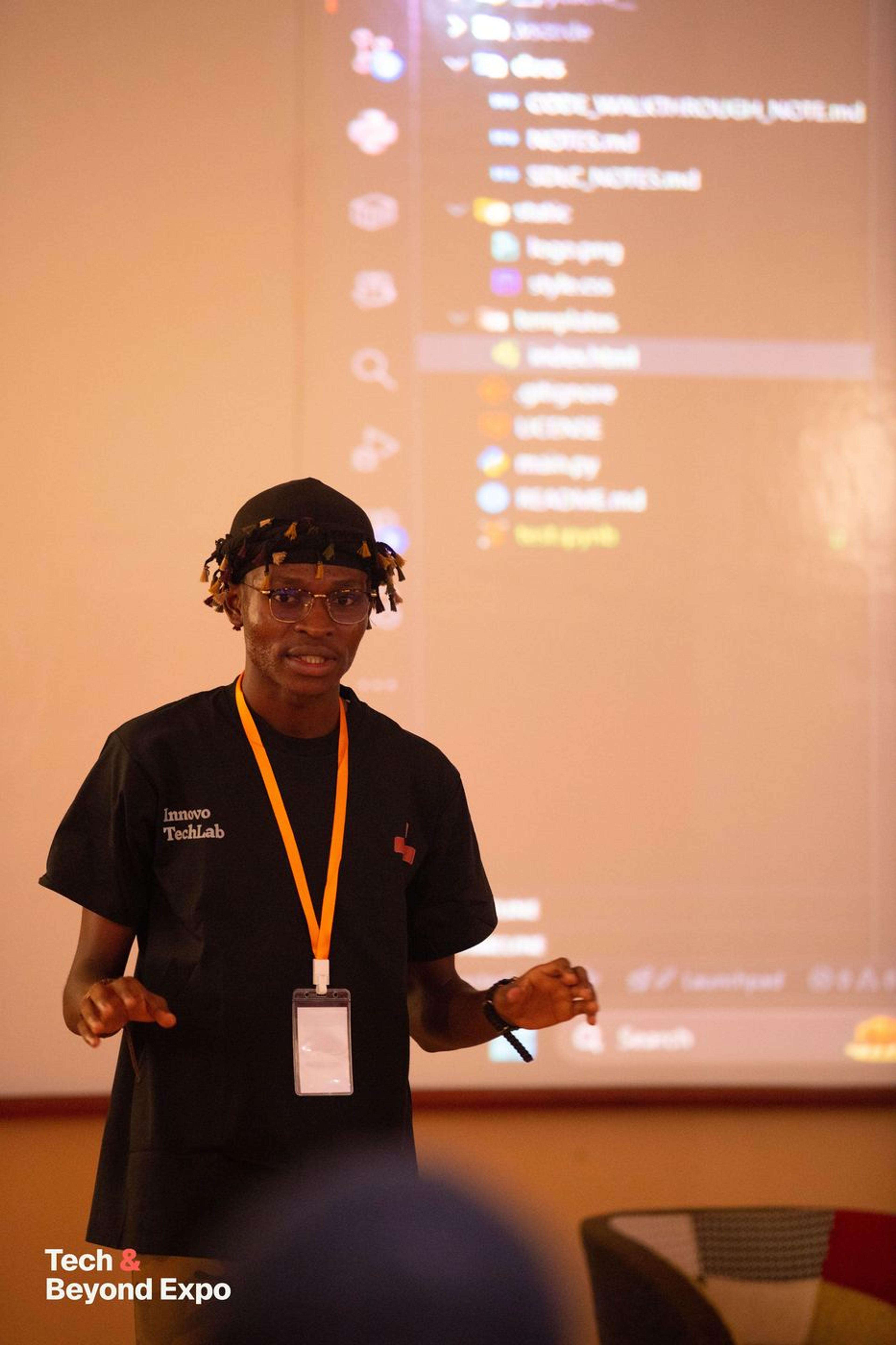 A speaker walking through code on a projected screen