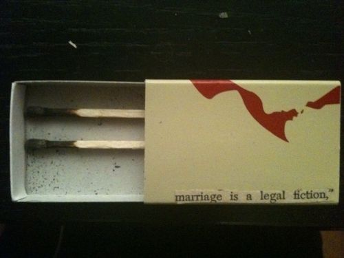 “Marriage Is A Legal Fiction,” excerpt clipping from vintage romance novel, matchbox, two burnt matches.