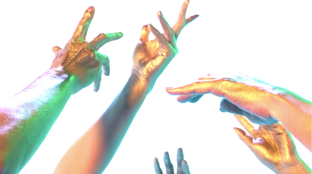 Three painted golden hands in movement in the air.