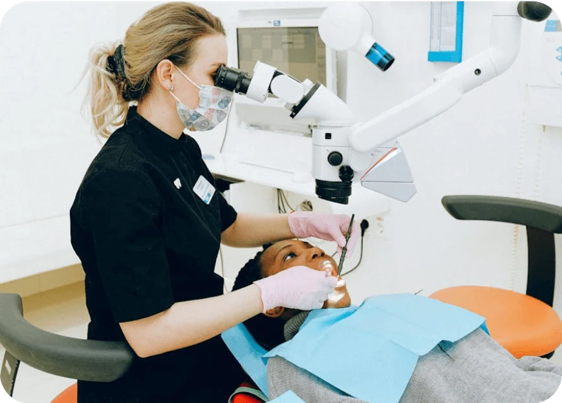 Dentist using a dental microscope during treatment