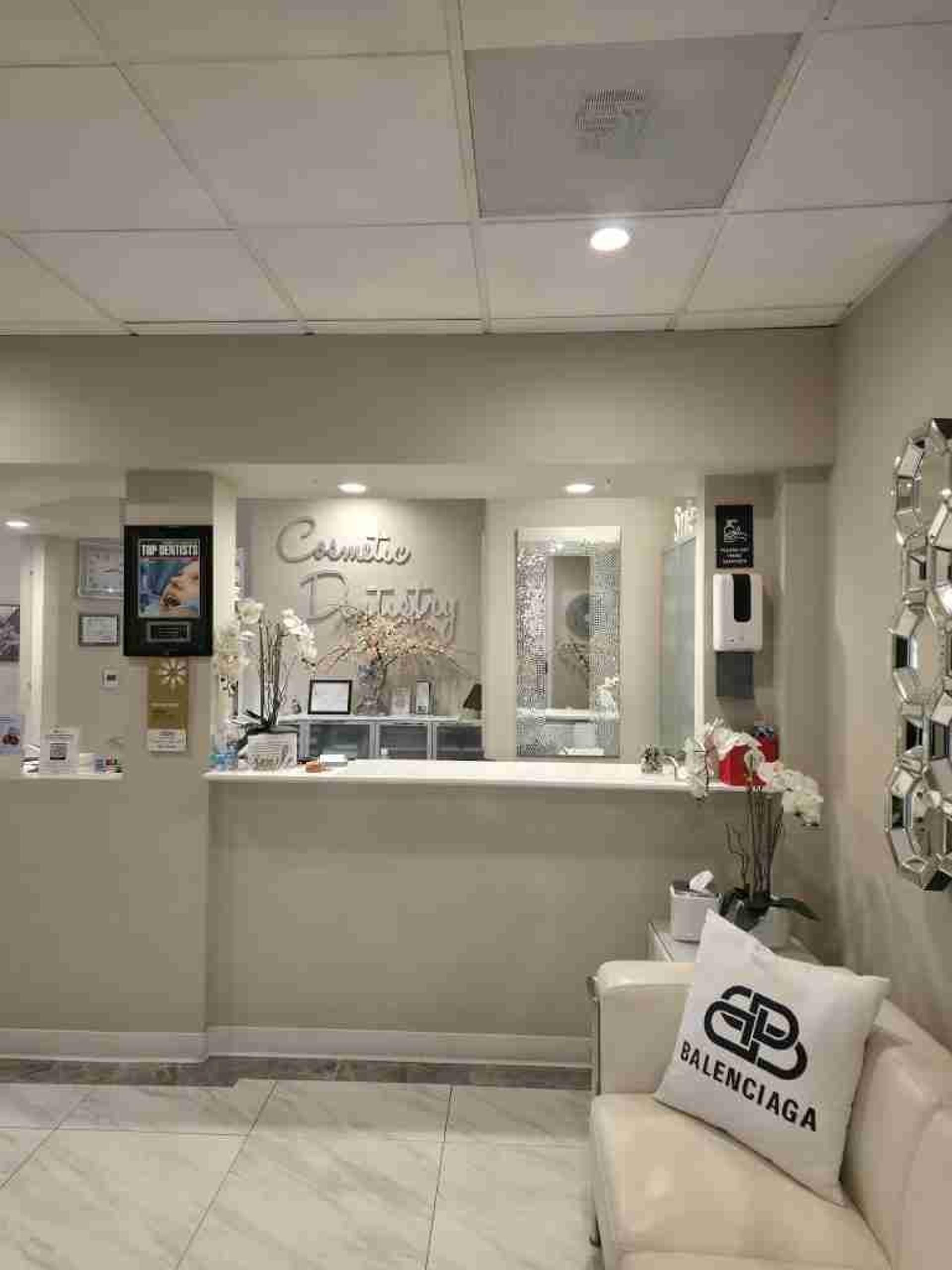 Reception desk and waiting area with the Cosmetic Dentistry sign