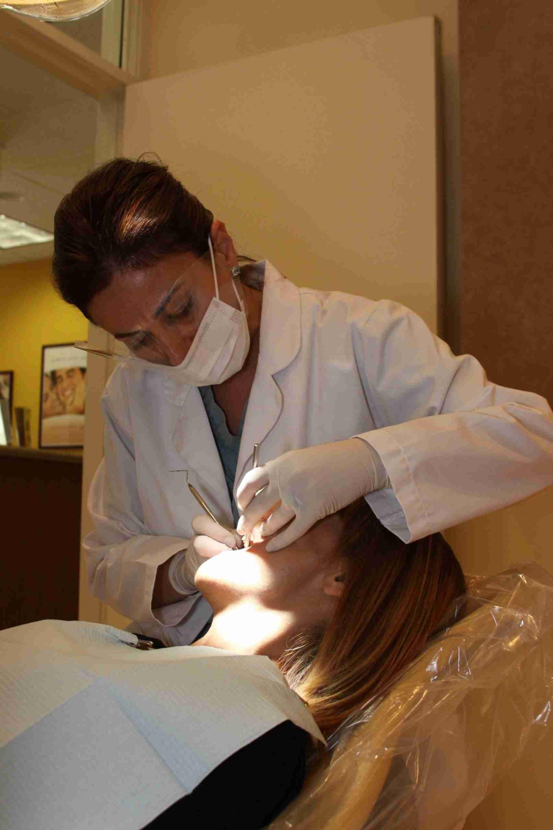 Dentist examining a patient in the dental chair