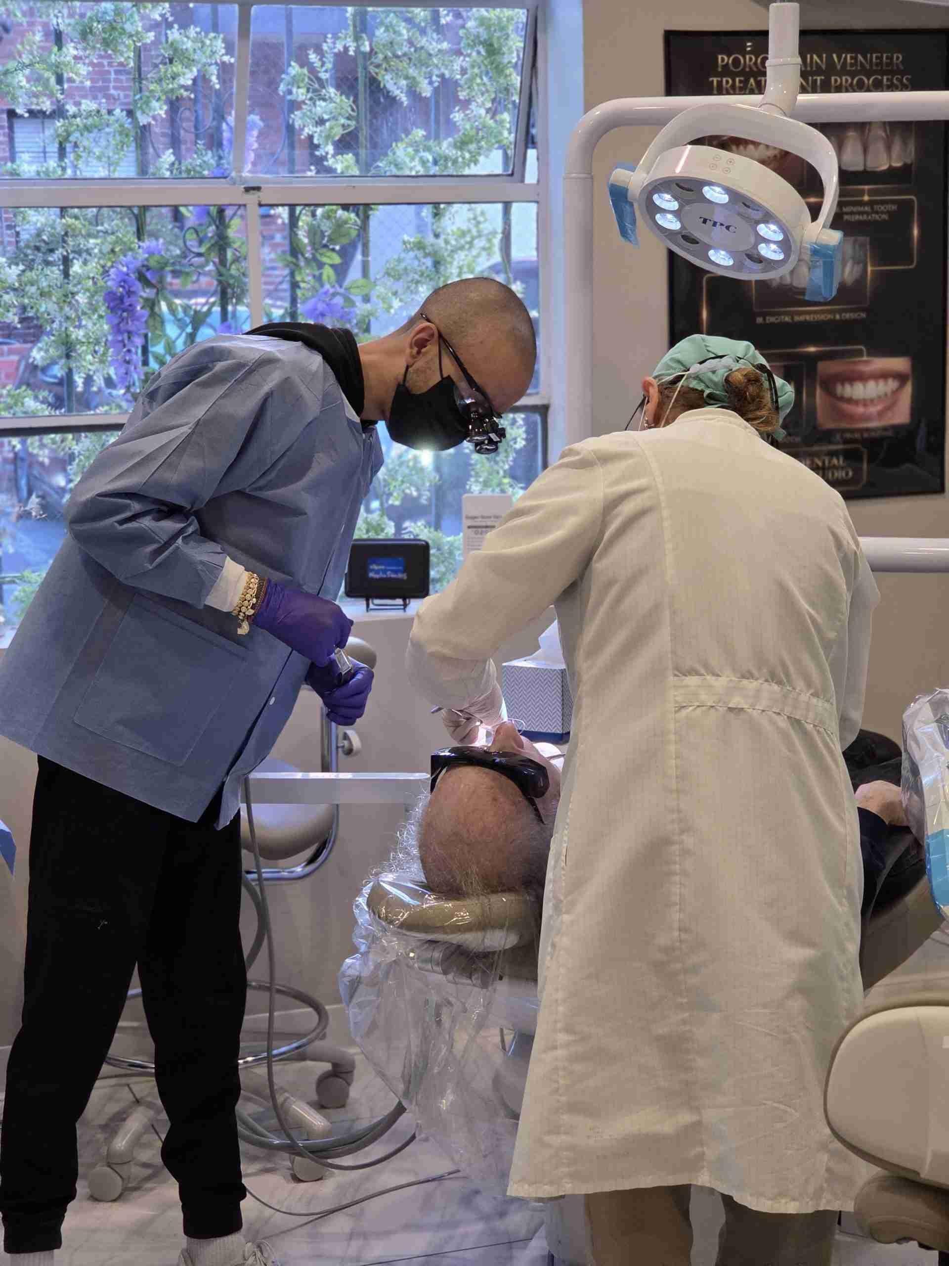 Two clinicians treating a patient in the treatment room