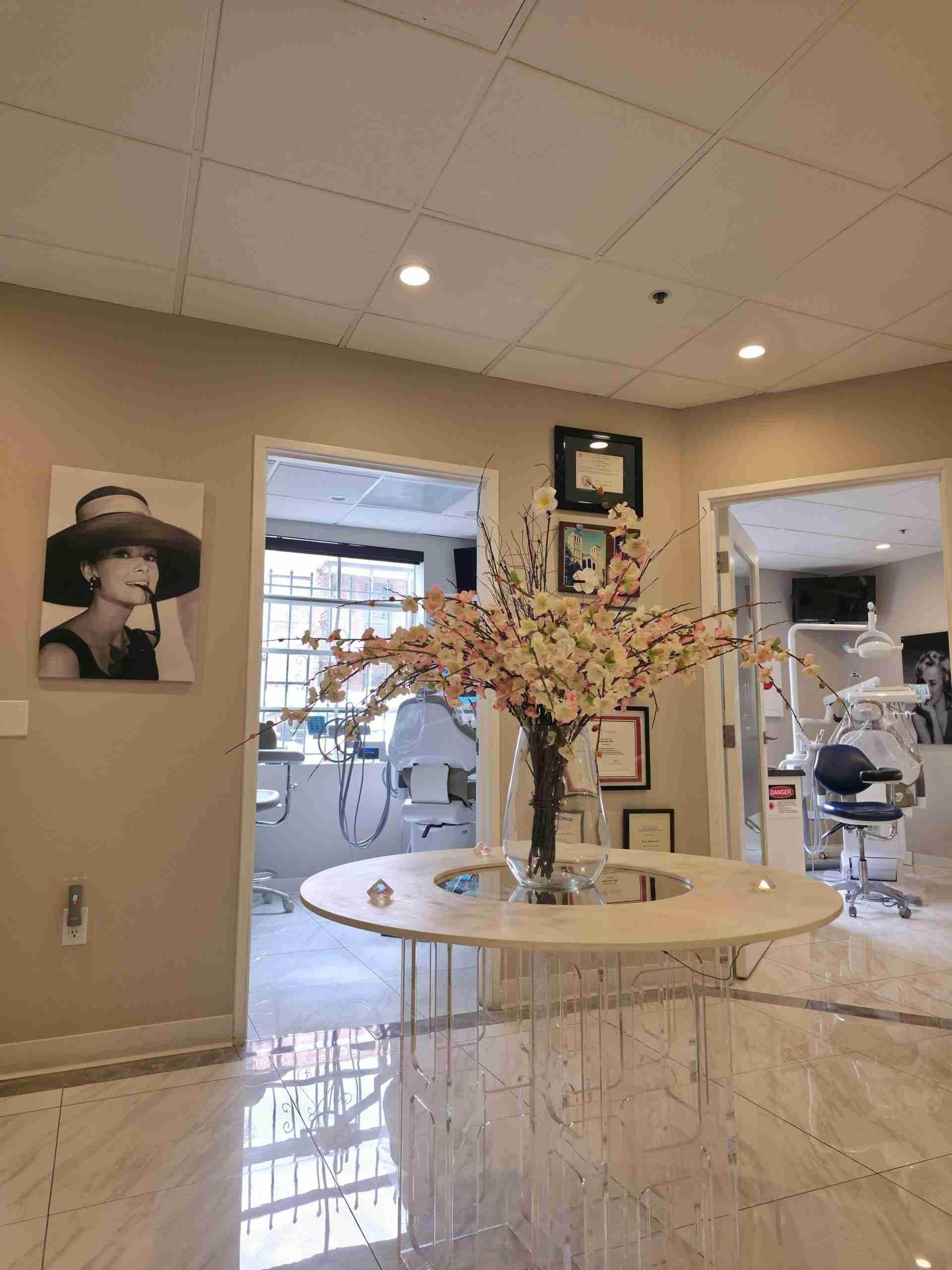 Office hallway with a round table and flowers leading to the treatment rooms