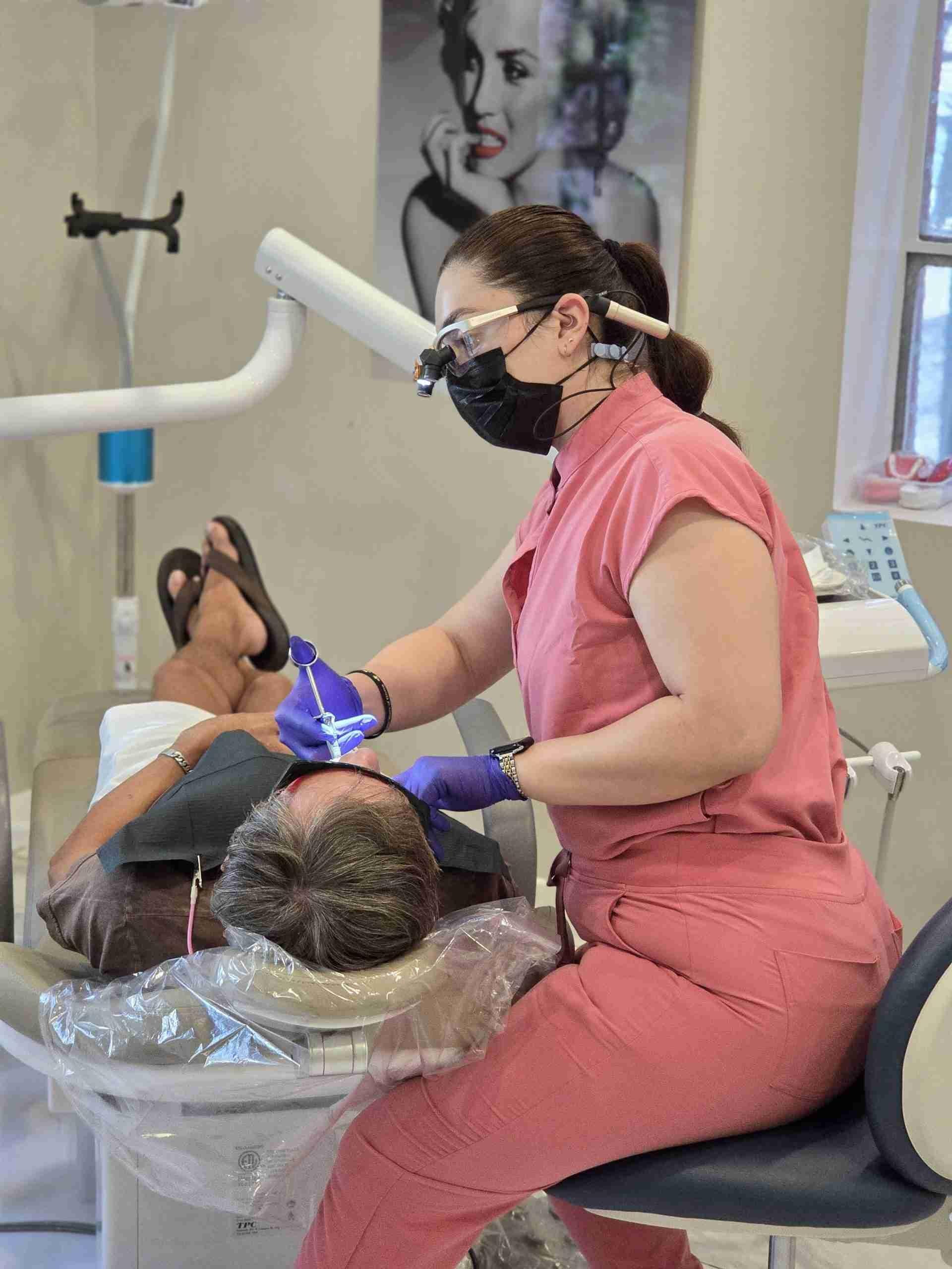 Clinician treating a patient in the dental chair