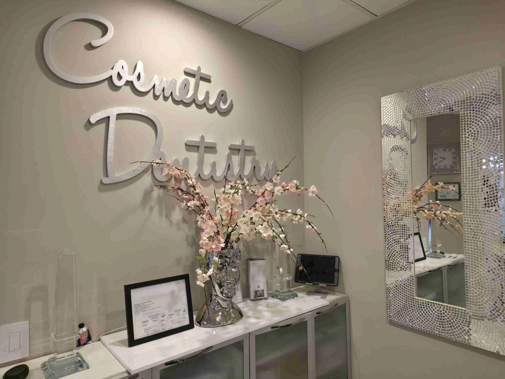 Cosmetic Dentistry sign with flowers and a mosaic mirror