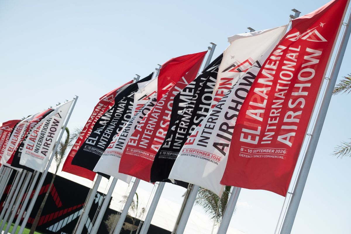 Rows of El Alamein International Airshow flags against a clear sky