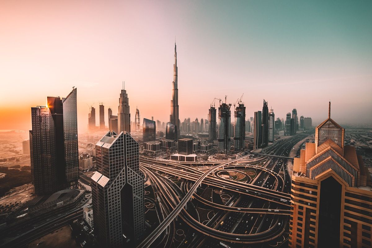 Dubai skyline at golden hour with Burj Khalifa and Sheikh Zayed Road, a popular filming location