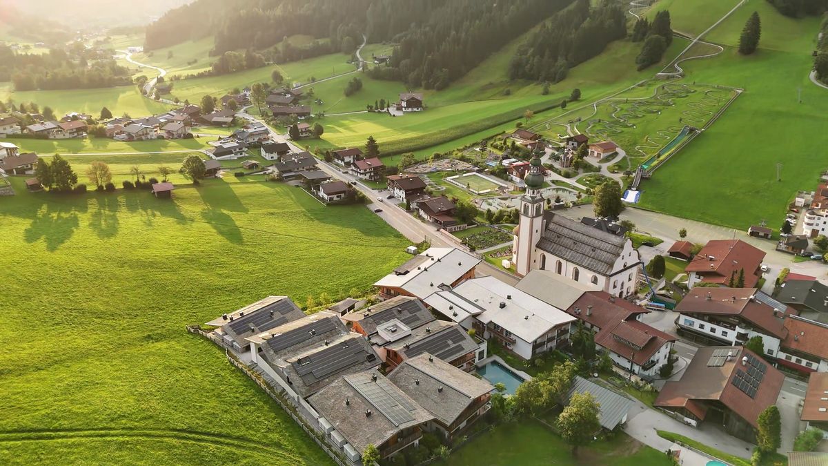 Golden-hour aerial view of the Wildschönau valley around Mount Med Resort