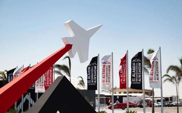 The El Alamein International Airshow 2026 entrance, with show flags and the jet sculpture