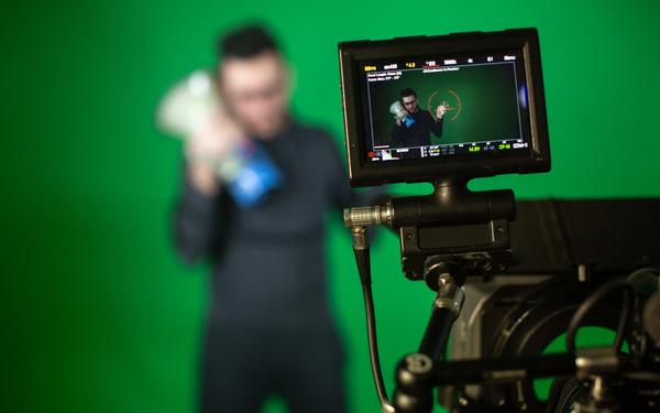 Camera man shoots on camera person with speaker