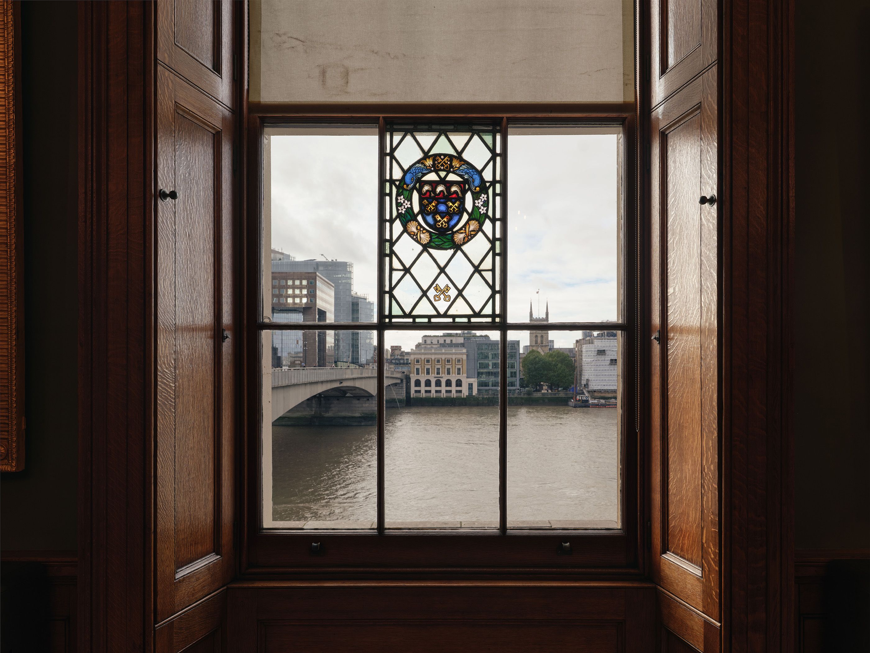 View out across the Thames through a Georgian style window with a central stain glassed panel