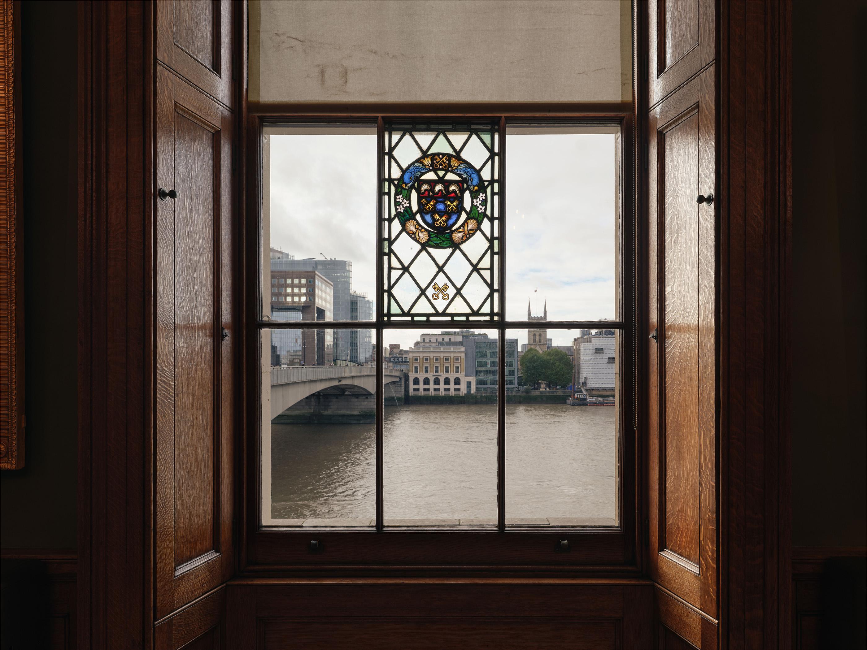 View out across the Thames through a Georgian style window with a central stain glassed panel