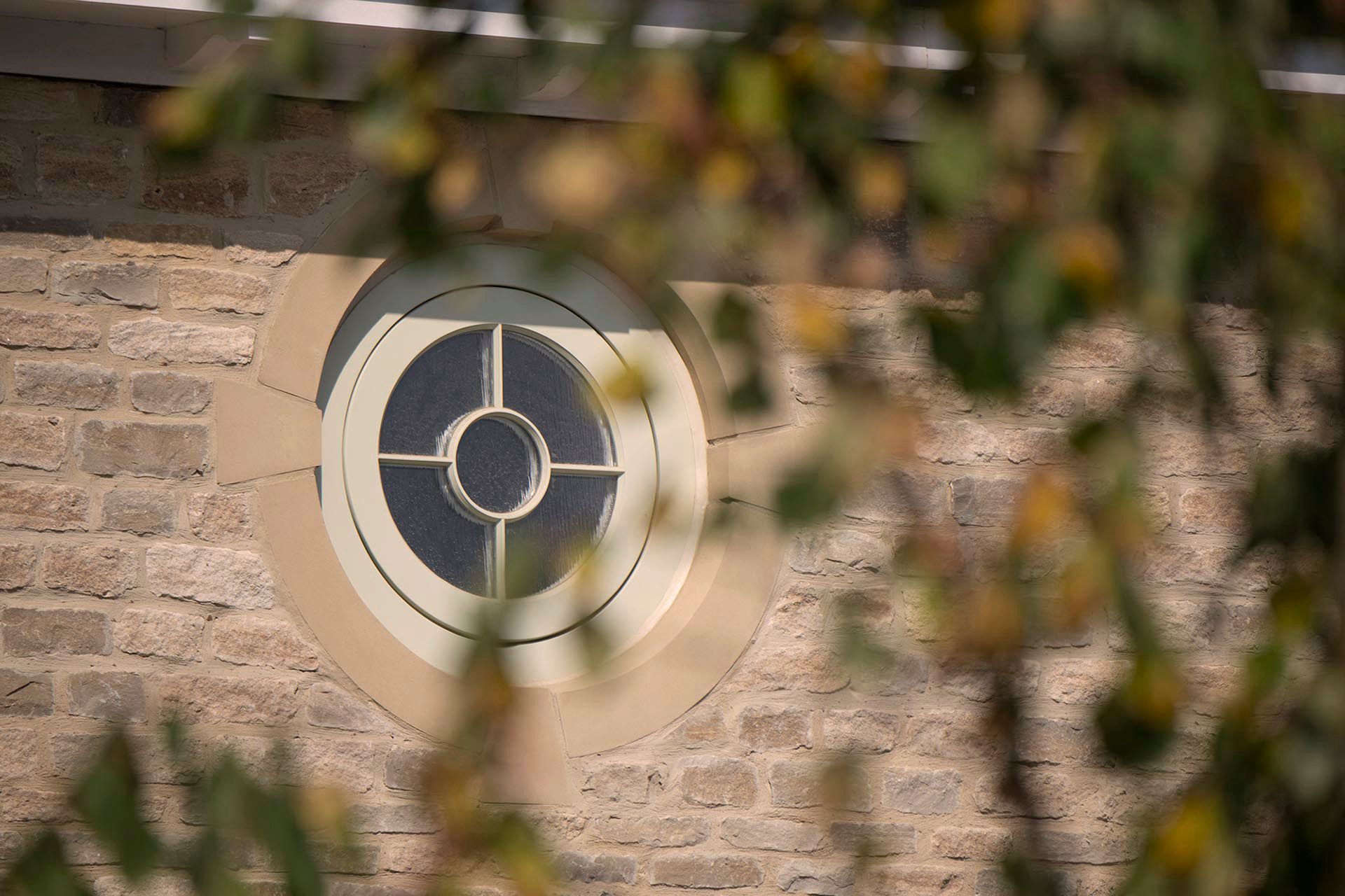 Stone cast round window within a new house at Park View 