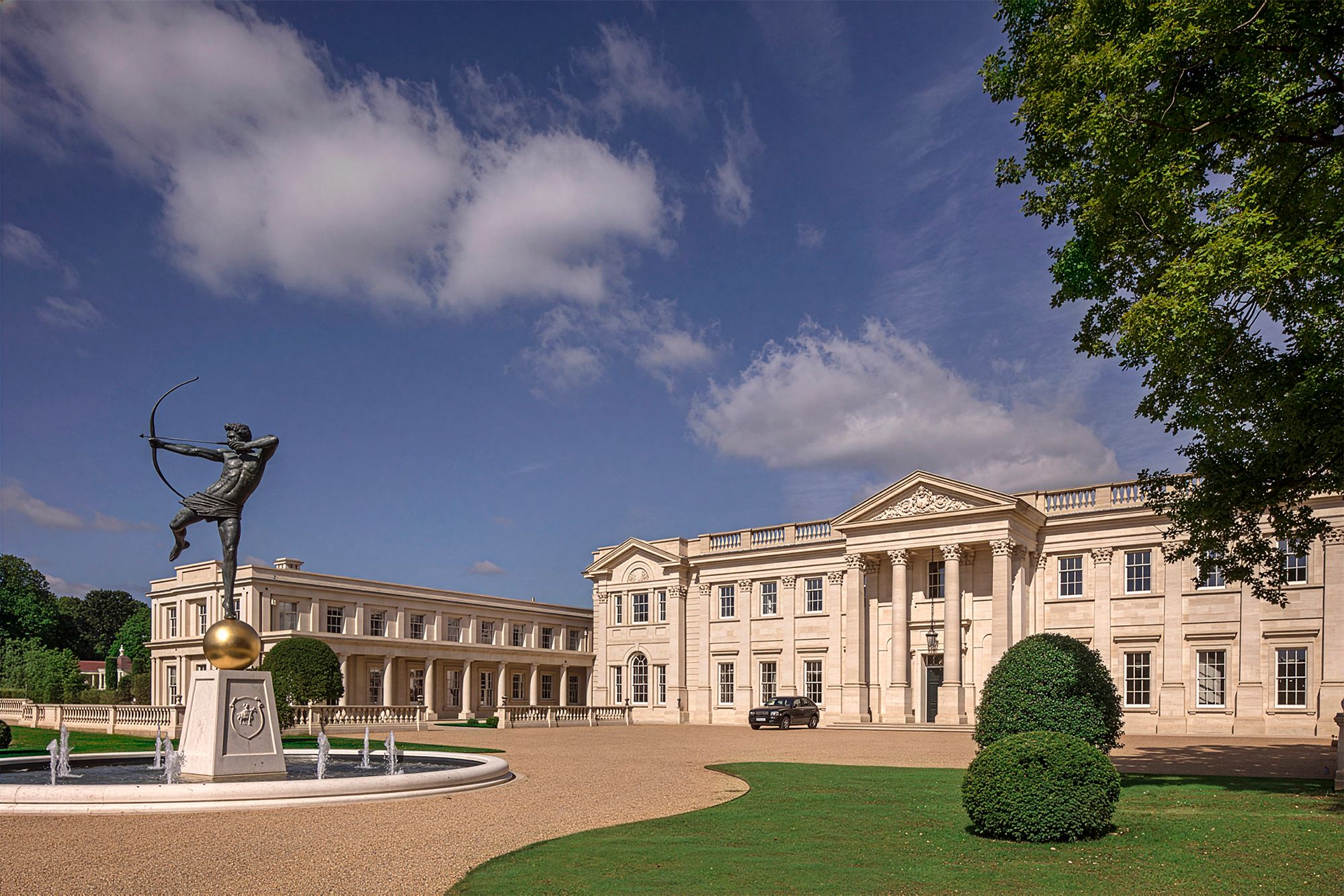 Façade and forecourt of a Surrey mansion house