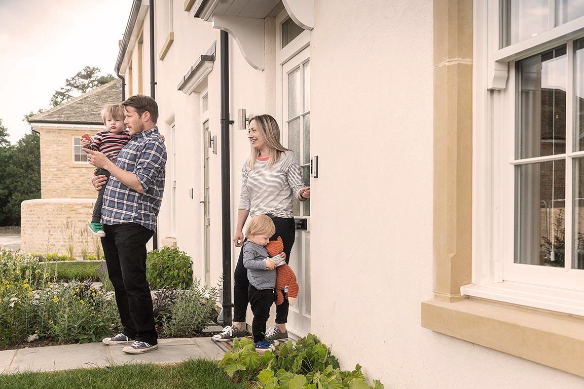 Family outside their front door at the new home in Park View