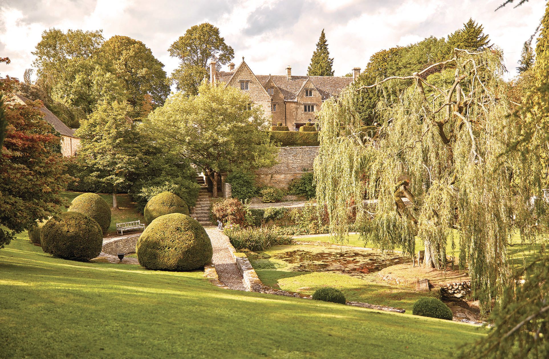 Rear elevation and gardens of the Cotswold manor house 