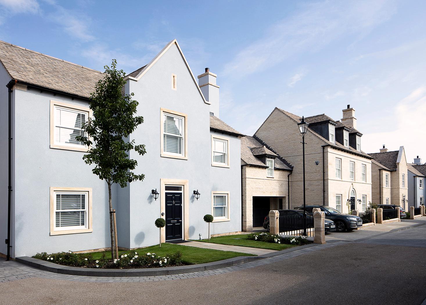 Pale blue rendered and natural stone new homes