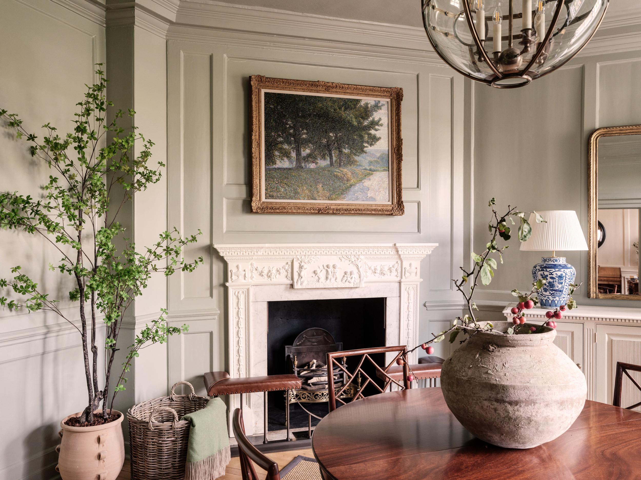 Entrance hall with feature fireplace, artwork, central table and ornaments