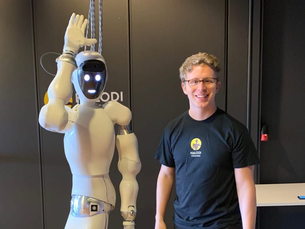 Audrow standing next to the Eve humanoid