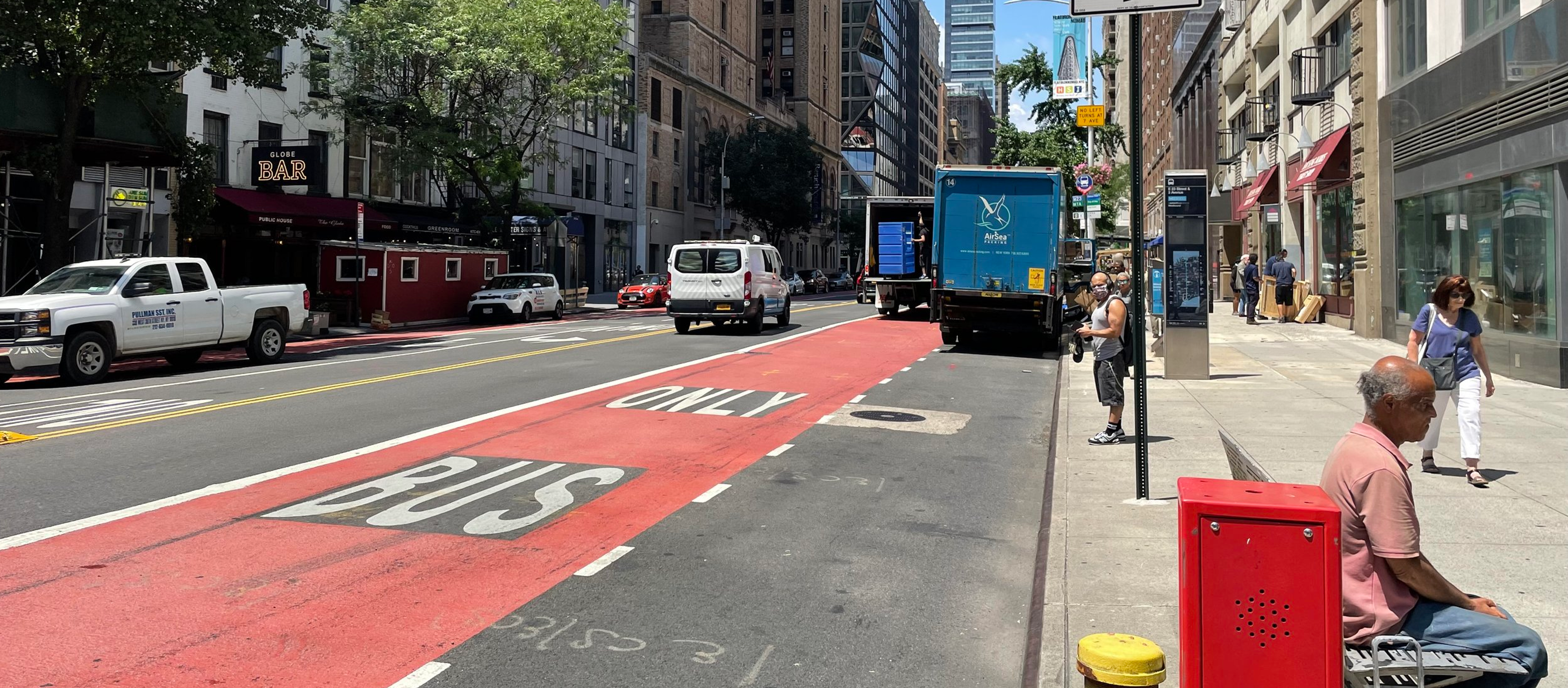 A bus lane on a city street designated by red paint