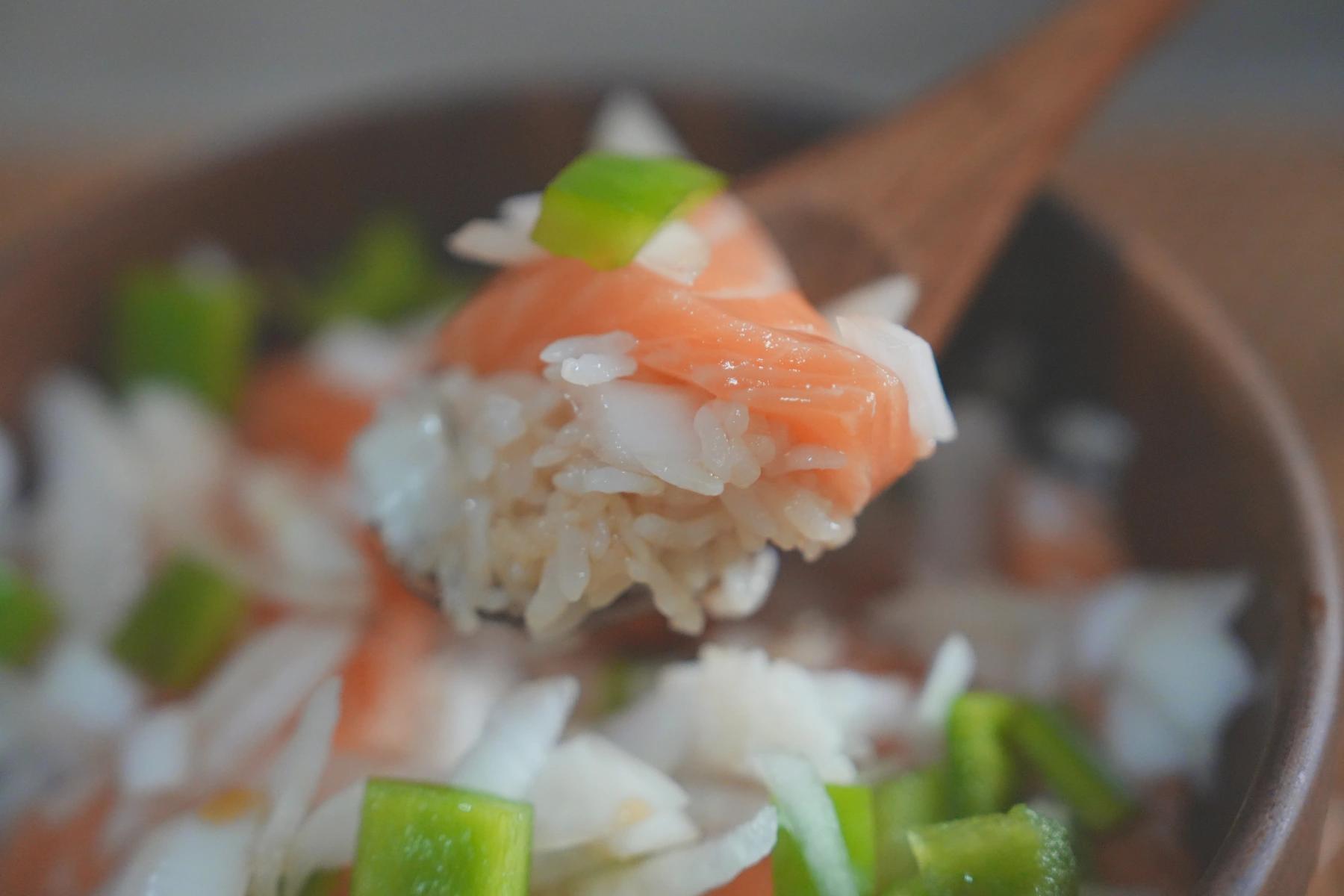 holding rice and salmon