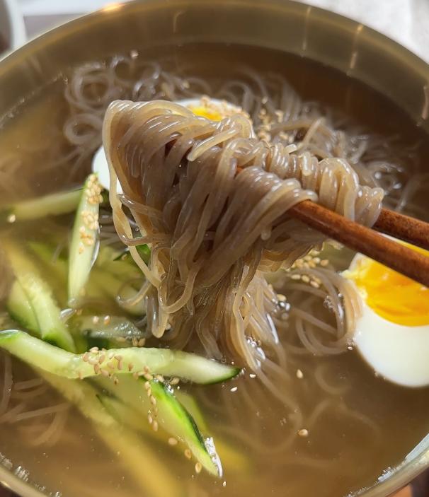 holding noodles with chopsiticks