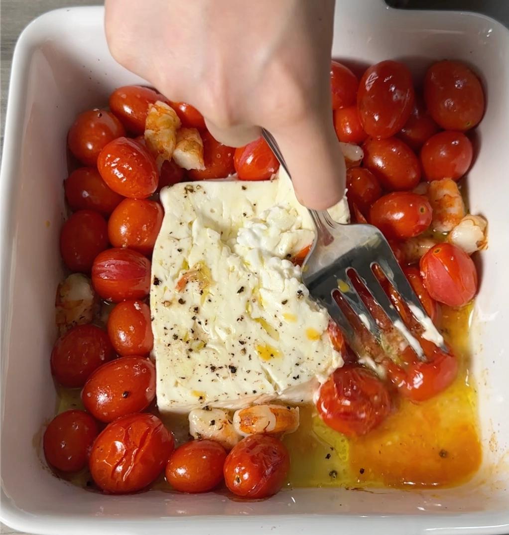 mashing tomatoes and feta cheese