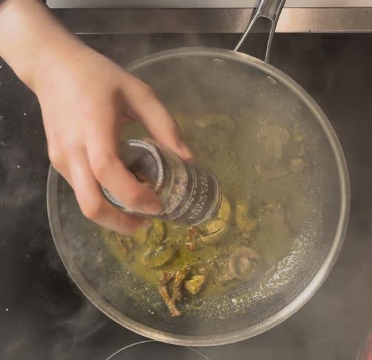 adding red pepper flakes into the pan