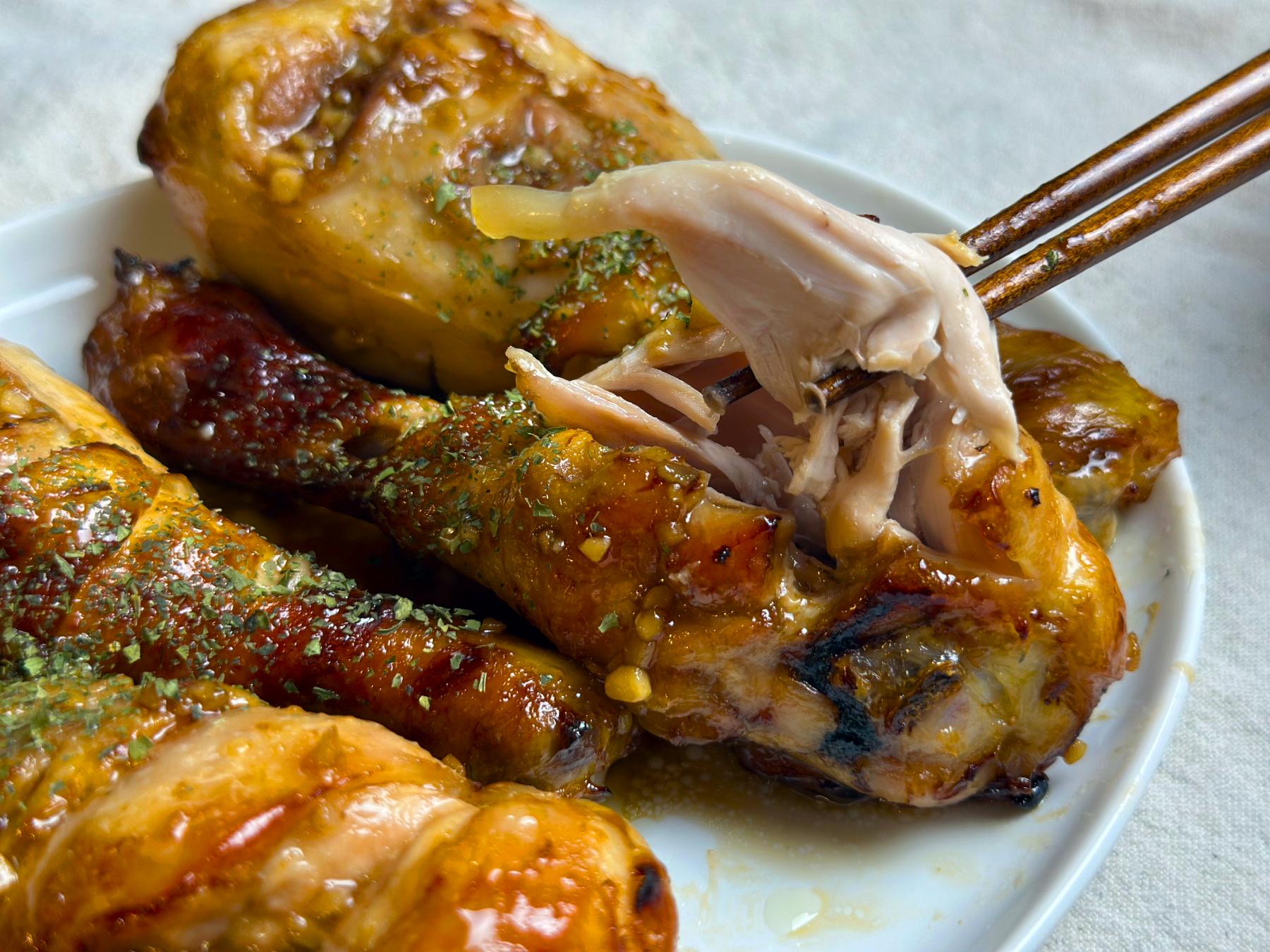 holding soy garlic chicken with chopsticks