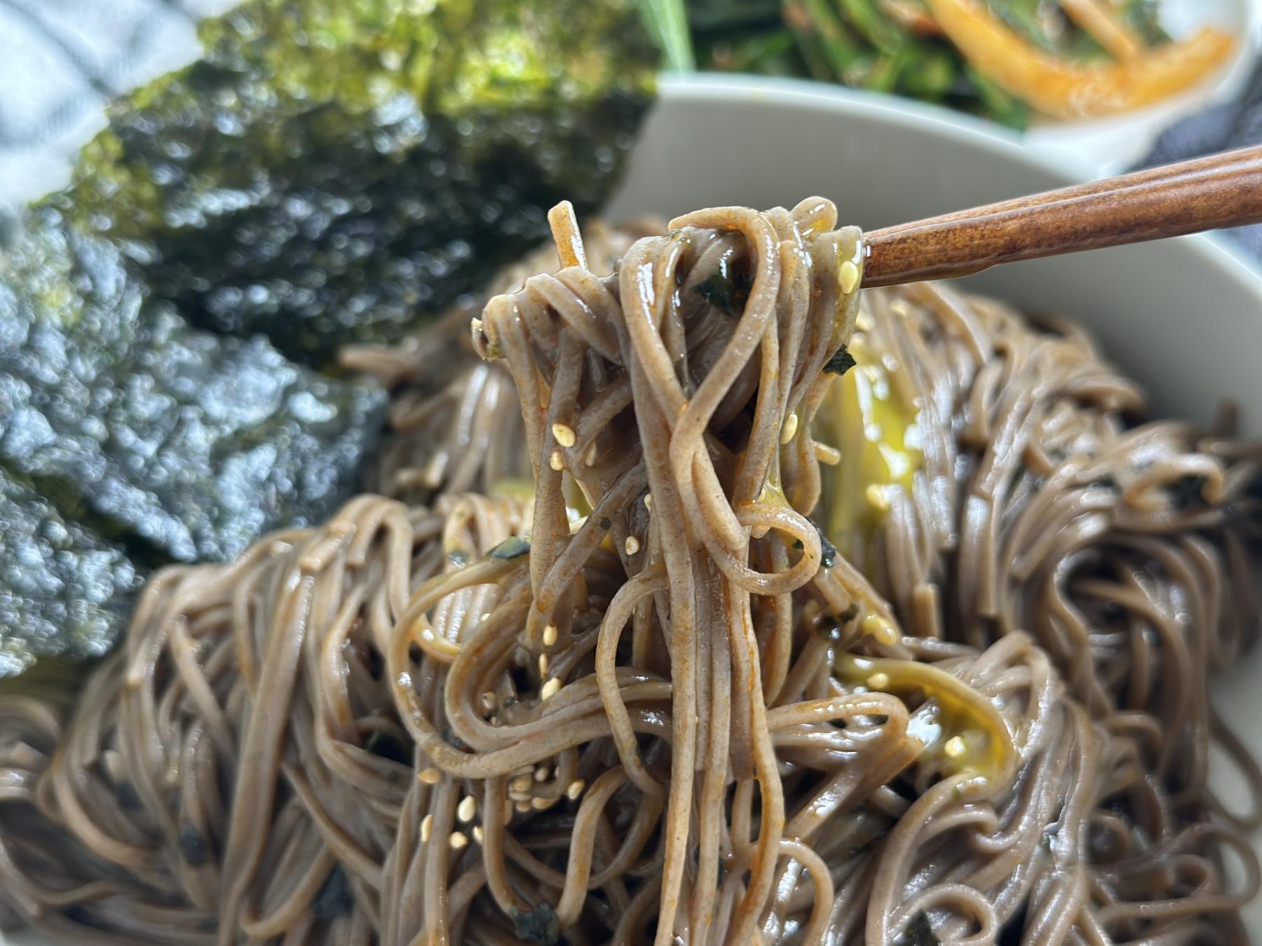 holding noodle with chopsticks