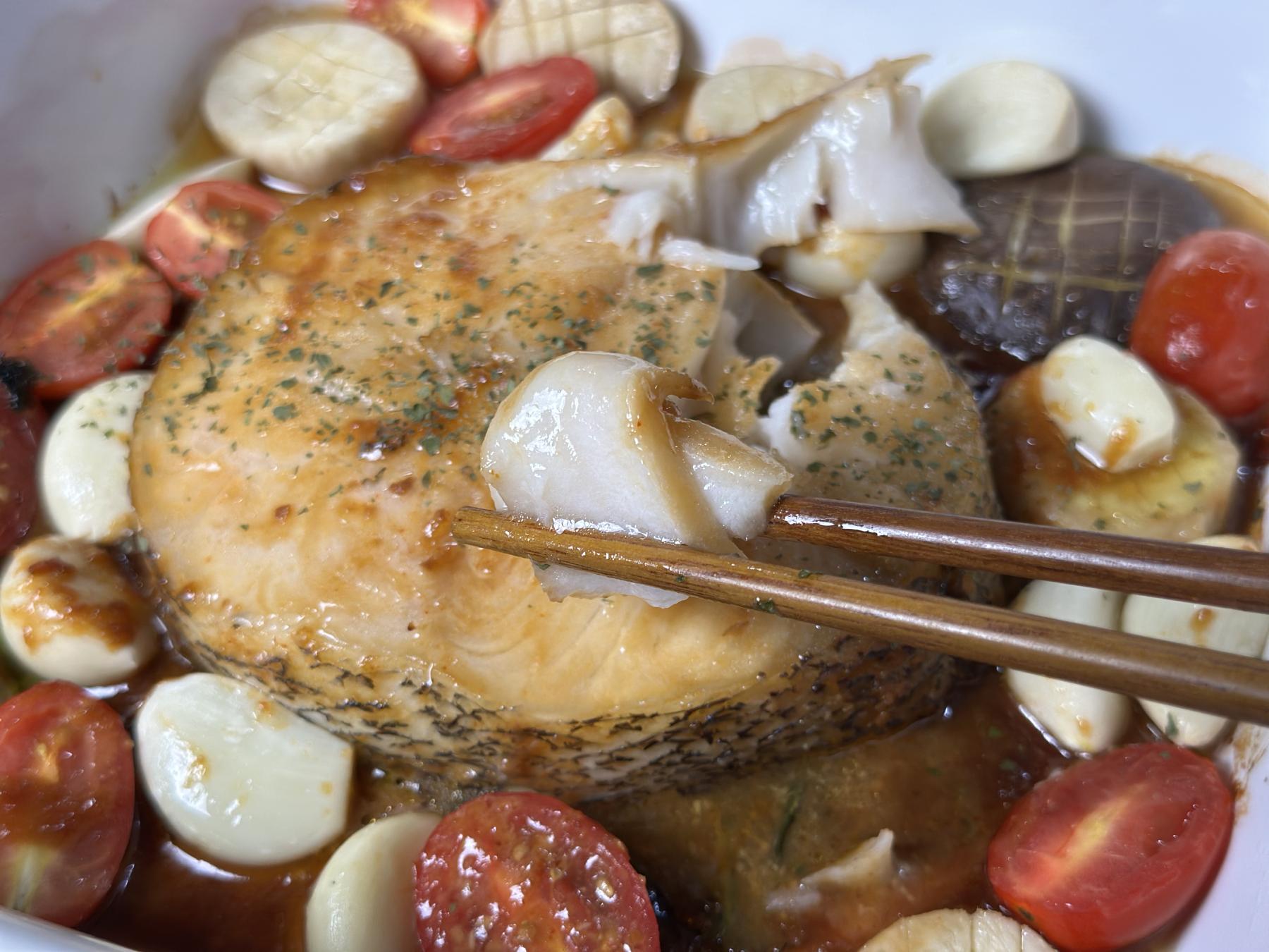 holding fish meat with chopsticks
