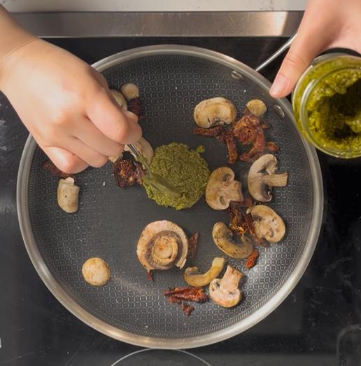 adding basil pesto into the pan