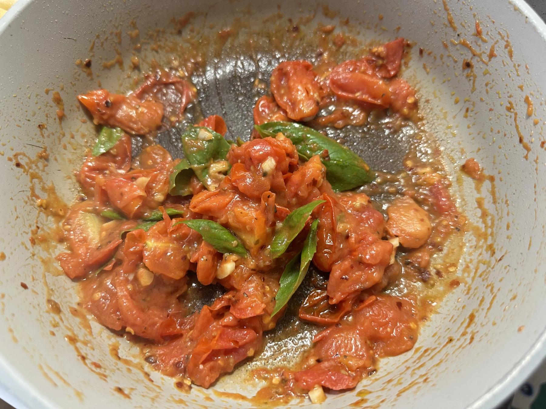 basil added to the mashed tomatoes